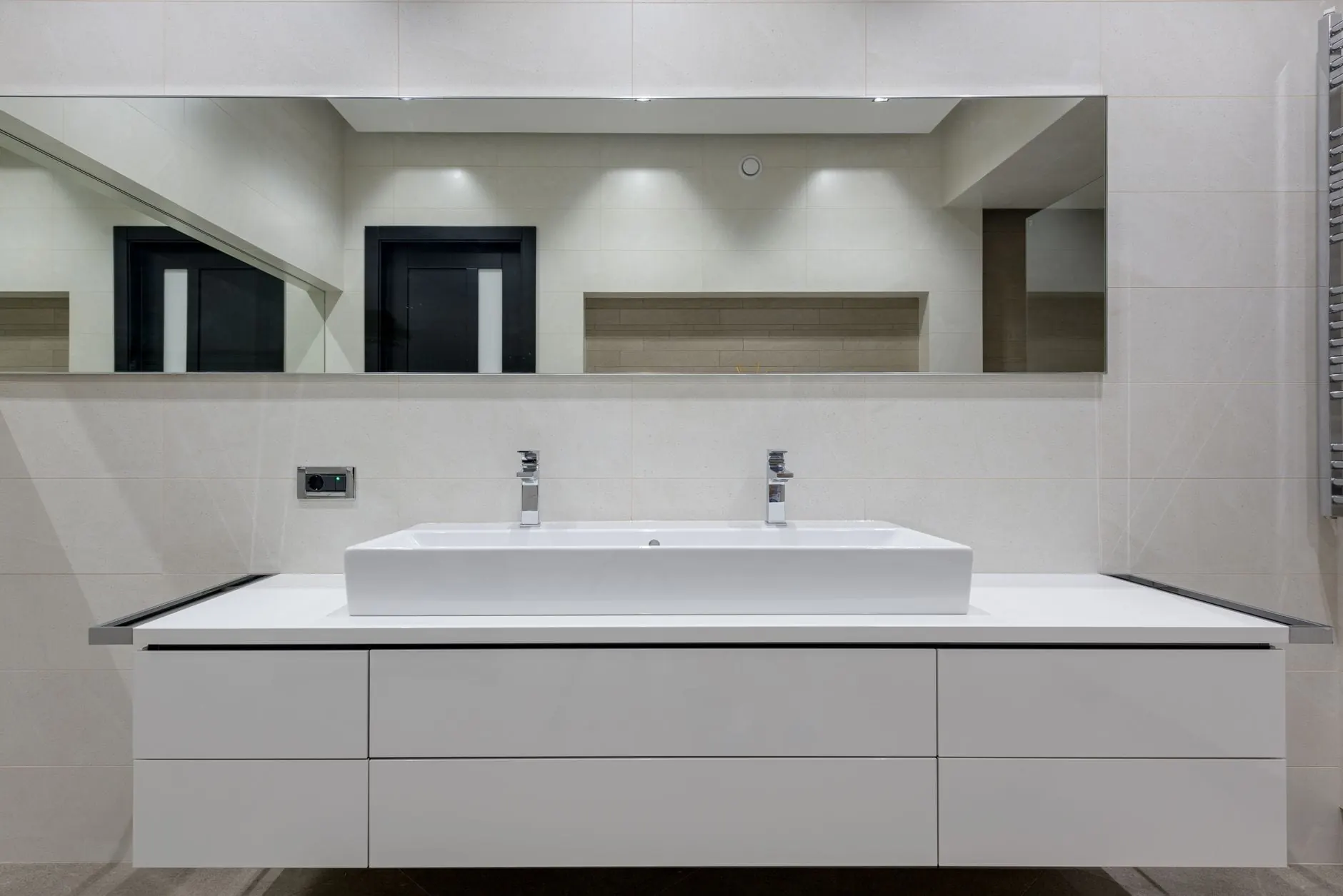 Wide white vanity top with an integrated rectangular basin beneath a full-width mirror